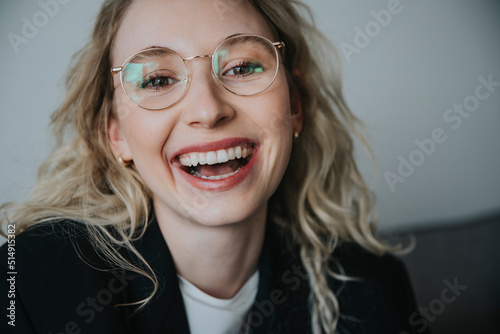 Blond businesswoman laughing wearing eyeglasses