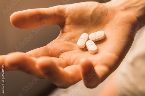 Hand of woman with pills photo