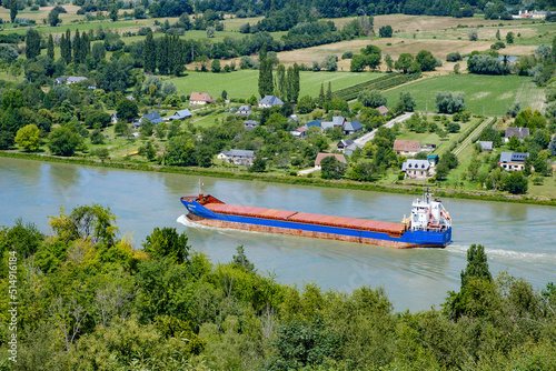 cargo boat travelling down the river Seine, near Barneville-sur-Seine, Eure, Normandy, France 