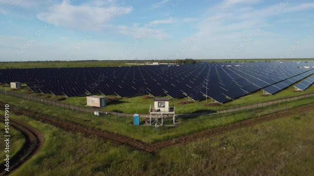 Aerial top view of a solar panels power plant. Photovoltaic solar panels at sunrise and sunset in countryside from above. Modern technology, climate care, earth saving, renewable energy concept.