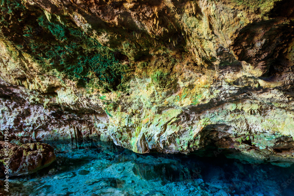 View of beautiful natural pool of crystal clear water formed in a rocky cave with stalagmites and stalagmites. Kuza cave in Zanzibar, Tanzania View of beautiful natural pool of crystal clear water formed in a rocky cave with stalagmites and stalagmites. Kuza cave in Zanzibar, Tanzania