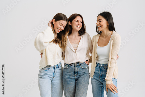 Three gorgeous brunette women posing at camera together