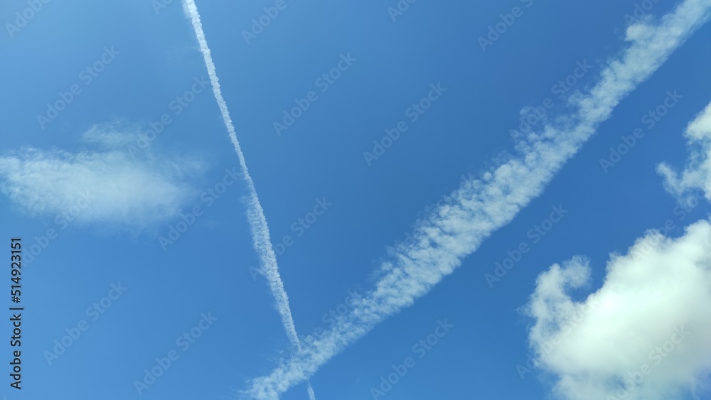 Abstract Defocused traces of clouds from two planes passing in a clear blue sky in the Cicalengka area, Indonesia Abstract Defocused traces of clouds from two planes passing in a clear blue sky in the Cicalengka area, Indonesia