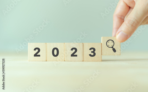 2023 trend and seeking new opportunities concept. Wooden cube with 2023, magnifying glass icon. Used for banner in trend concept in new year for monitoring new opportunities, process improvement.