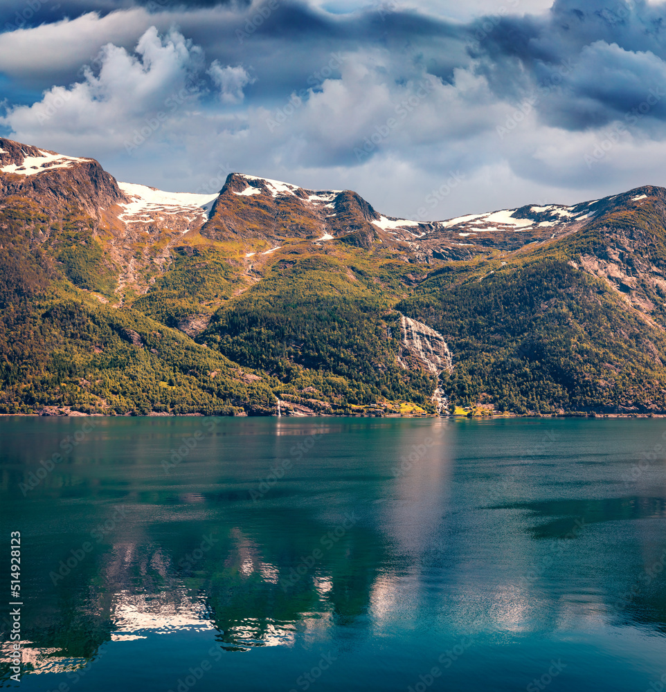 Fototapeta Beautifel summer scene of Hardangerfjord fjord with majestic waterfall, Lofthus port location, Ullensvang municipality, Hordaland county, Norway, Europe. Beauty of nature concept background.
