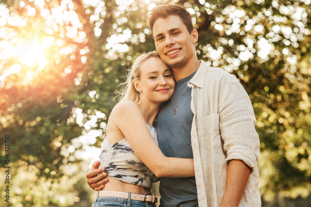 summer holidays, love and people concept - happy young couple hugging outdoors summer holidays, love and people concept - happy young couple hugging outdoors