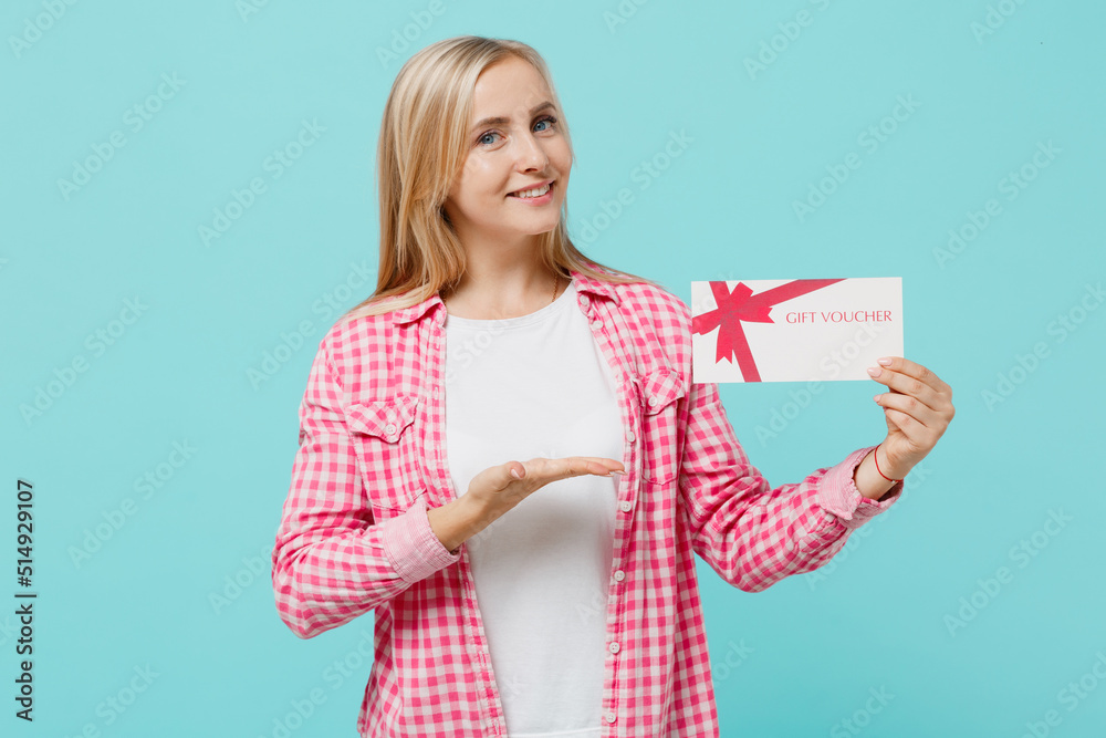 Young happy woman she 30s in pink shirt white t-shirt hold show gift certificate coupon voucher card for store isolated on plain pastel light blue background studio portrait. People lifestyle concept. Young happy woman she 30s in pink shirt white t-shirt hold show gift certificate coupon voucher card for store isolated on plain pastel light blue background studio portrait. People lifestyle concept.