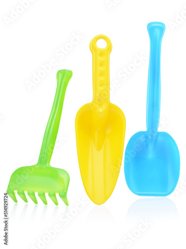 A set of children's toys for playing in the sandbox. Colored rake and shovel made of plastic, isolated on a white background, close-up. Early child development, children's leisure concept
