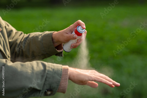 health care, protection and people concept - woman spraying insect repellent or bug spray to her hand at park © Syda Productions