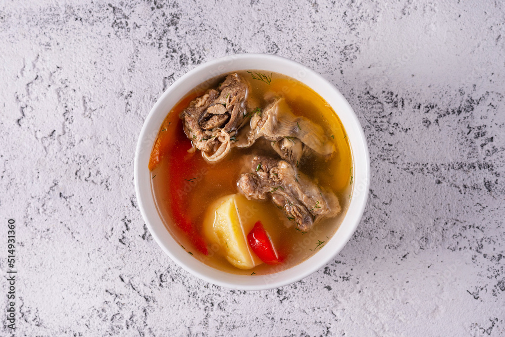 Shurpa soup with meat. on a light concrete background Shurpa soup with meat. on a light concrete background
