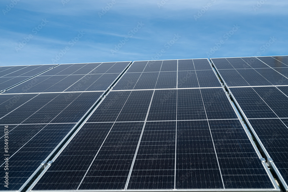 against the background of a beautiful blue sky new clean energy saving solar panels stand against the background of a beautiful blue sky new clean energy saving solar panels stand
