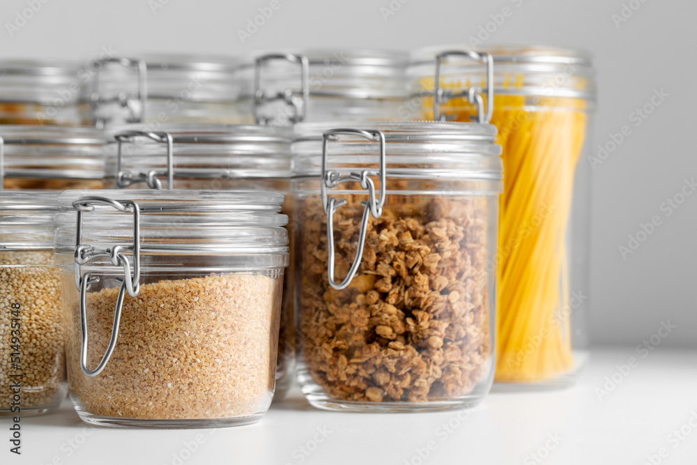 food storage, culinary and storage concept - jars with different cereals or groceries on table food storage, culinary and storage concept - jars with different cereals or groceries on table