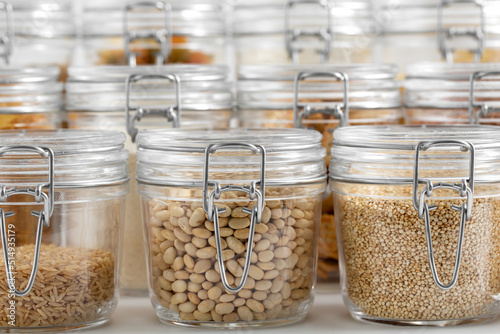 food storage, culinary and storage concept - jars with different cereals or groceries on table photo