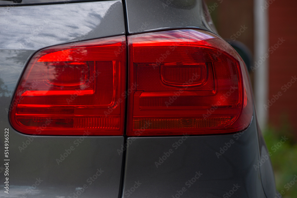 Close-up photo of the right rear light of a sports car on the street