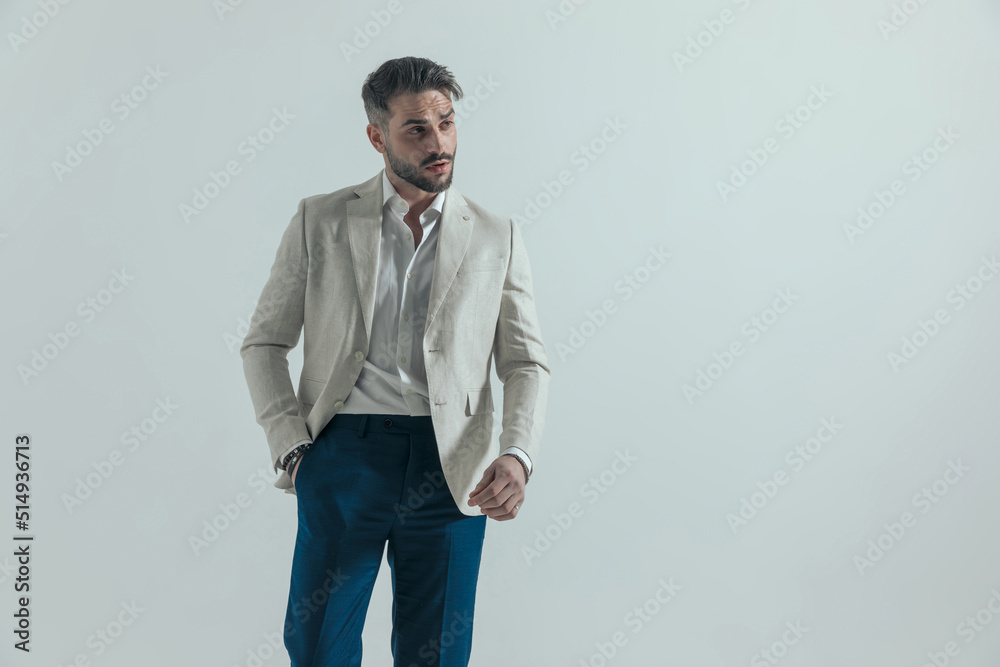 sexy unshaved man in suit with untied shirt holding hand in pocket sexy unshaved man in suit with untied shirt holding hand in pocket