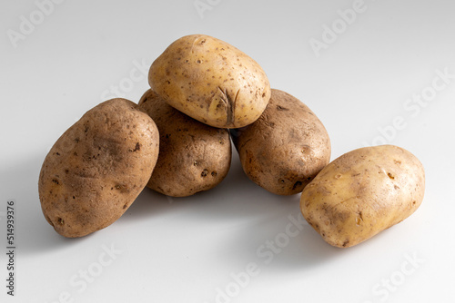 vegetable, food and culinary concept - close up of potatoes on table