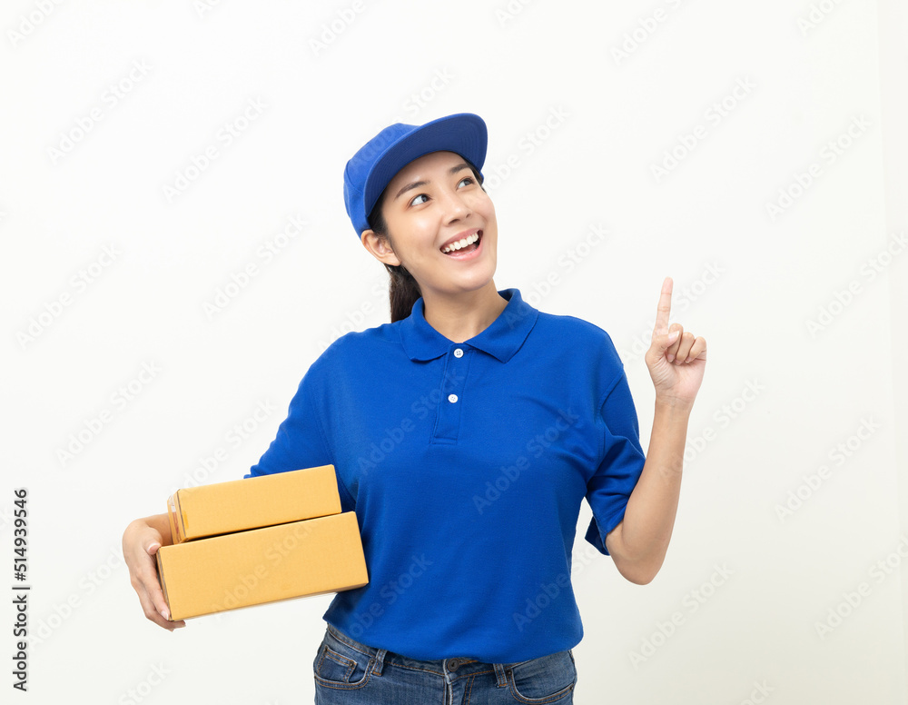 Happy delivery asian woman in blue uniform standing holding parcel cardboard box on isolated white background. Smiling female delivery sending box package service worker. Happy delivery asian woman in blue uniform standing holding parcel cardboard box on isolated white background. Smiling female delivery sending box package service worker.