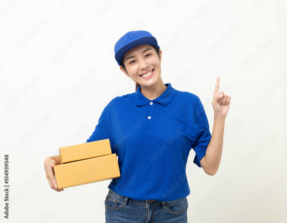 Happy delivery asian woman in blue uniform standing holding parcel cardboard box on isolated white background. Smiling female delivery sending box package service worker. Happy delivery asian woman in blue uniform standing holding parcel cardboard box on isolated white background. Smiling female delivery sending box package service worker.