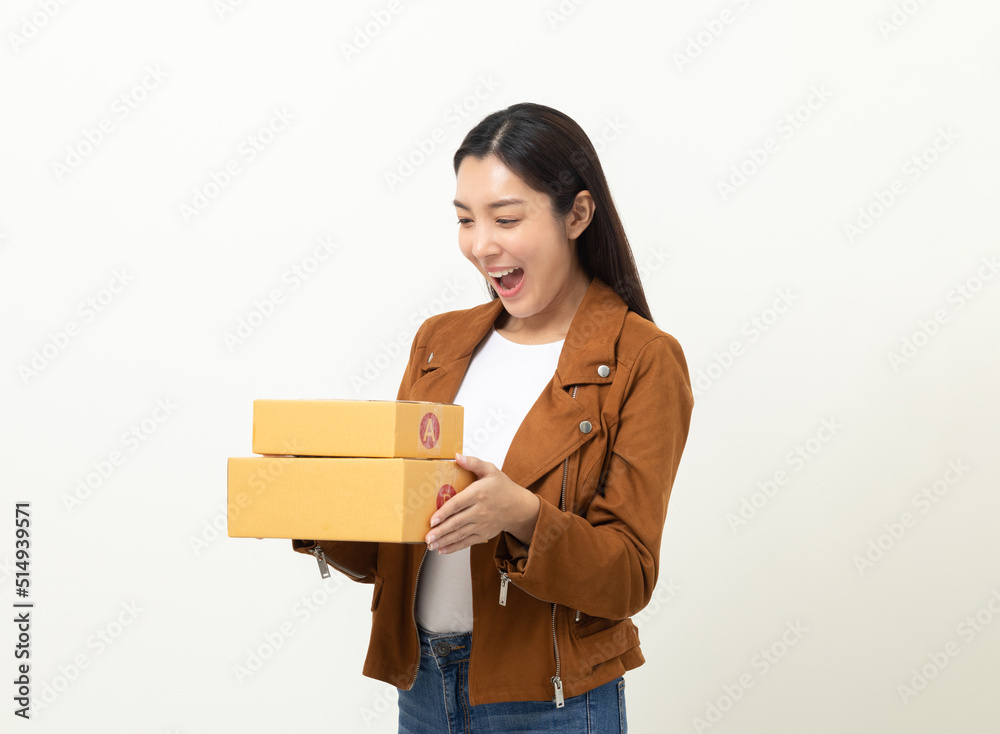 Young excited beautiful asian woman with many parcel cardboard standing on isolated white background. Cheerful female holding lot of parcel box receive from the delivery service Young excited beautiful asian woman with many parcel cardboard standing on isolated white background. Cheerful female holding lot of parcel box receive from the delivery service