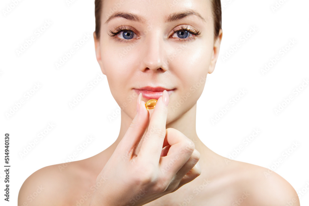 Smiling young woman holding fish oil capsule. Smiling young woman holding fish oil capsule.