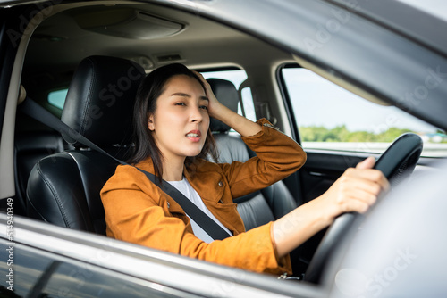 Young asian woman has broken down car on the road she feeling serious and stressed.Look for someone help. Driving during rush hour But the traffic is very congested. Shocked face © Chanakon