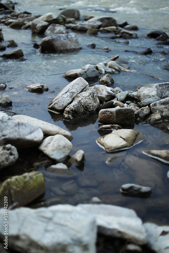 Water stream with stones, vertically. Mountain river.