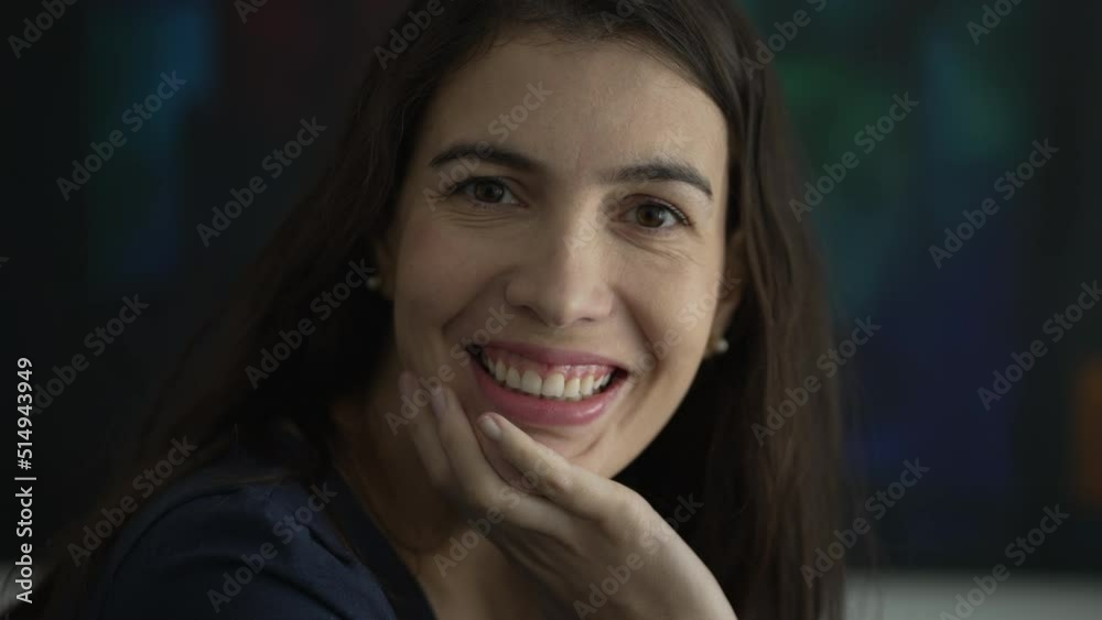 Portrait of woman in 30s smiling. Person face closeup looking at camera Portrait of woman in 30s smiling. Person face closeup looking at camera