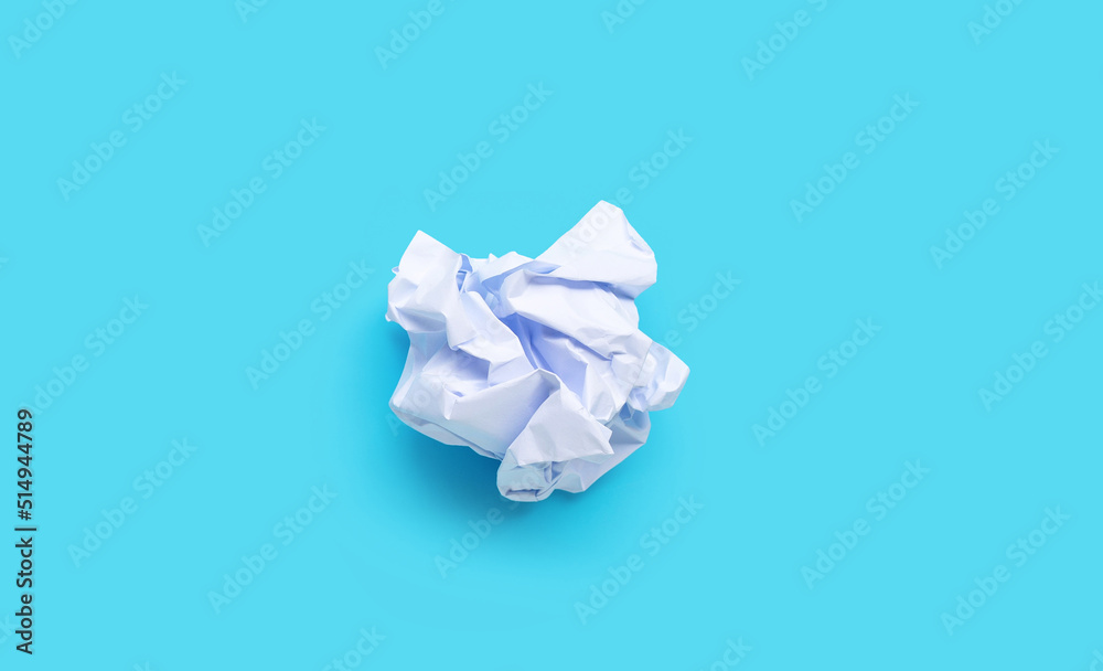 White crumpled paper balls on blue background. Ideas and creative thinking concept. Copy space White crumpled paper balls on blue background. Ideas and creative thinking concept. Copy space