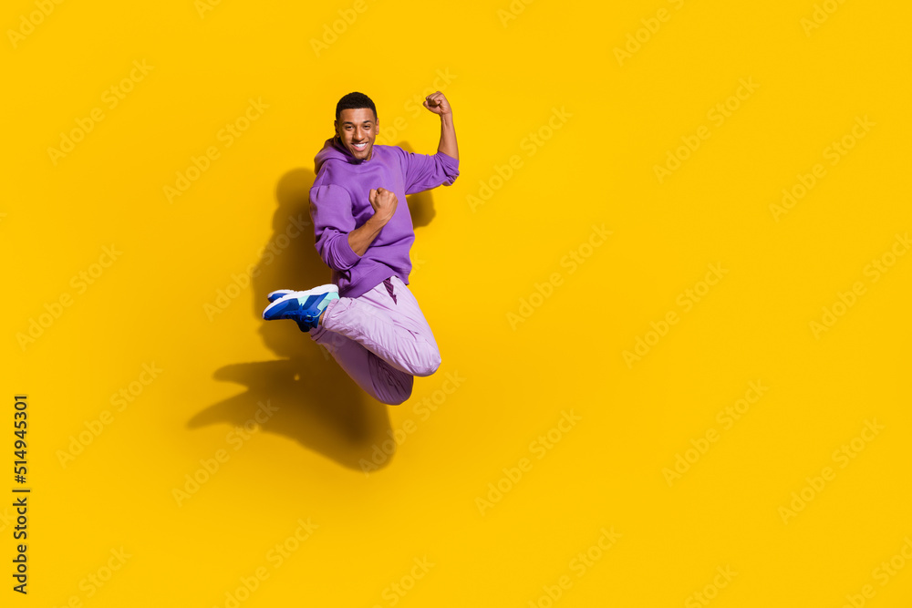 Full length body size view of attractive trendy cheerful guy jumping rejoicing win isolated on vivid yellow color background