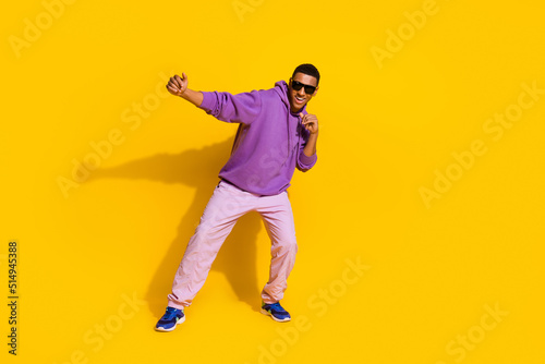 Full length body size view of attractive cheerful guy dancing fighting moving isolated over vivid yellow color background