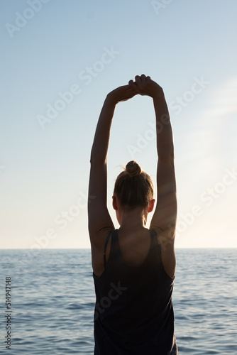 Woman doing yoga on the beach at sunset, Mahmutlar (Alanya, Turkey)