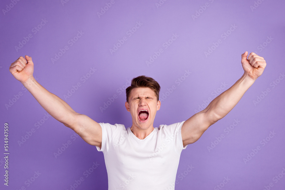 Cheerful excited man wearing blank t-shirt standing isolated over bright background celebrating success Cheerful excited man wearing blank t-shirt standing isolated over bright background celebrating success
