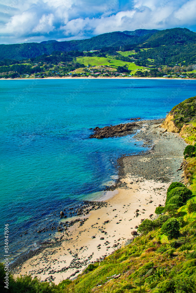 A crescent of sandy beach at the bottom of the hills by the entrance to Hokianga Harbour. Martin's Beach, Arai te Uru Reservce, Northland, New Zealand