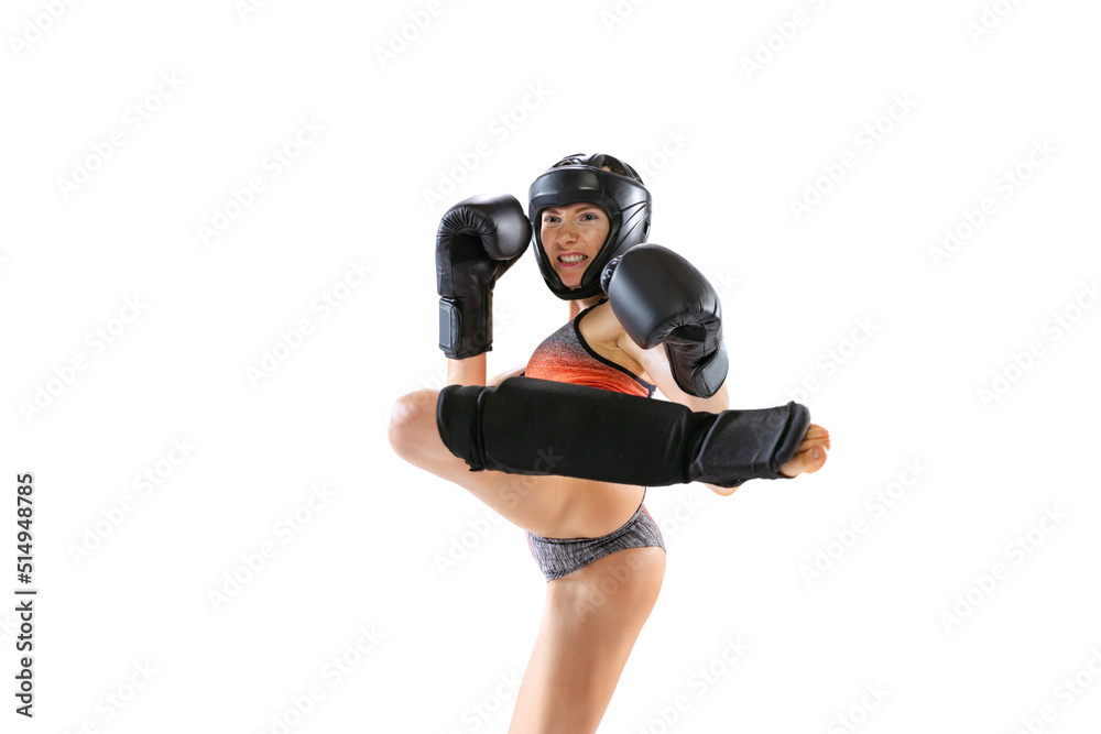 Enegry. Young female kickboxer wearing sports uniform and protective equipment in action isolated on white background. Sport, competition, power concept.