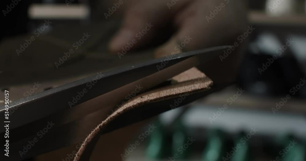 Close up view of tailor cut leather with scissors preparing blanks for making shoes, slow motion 4k Close up view of tailor cut leather with scissors preparing blanks for making shoes, slow motion 4k