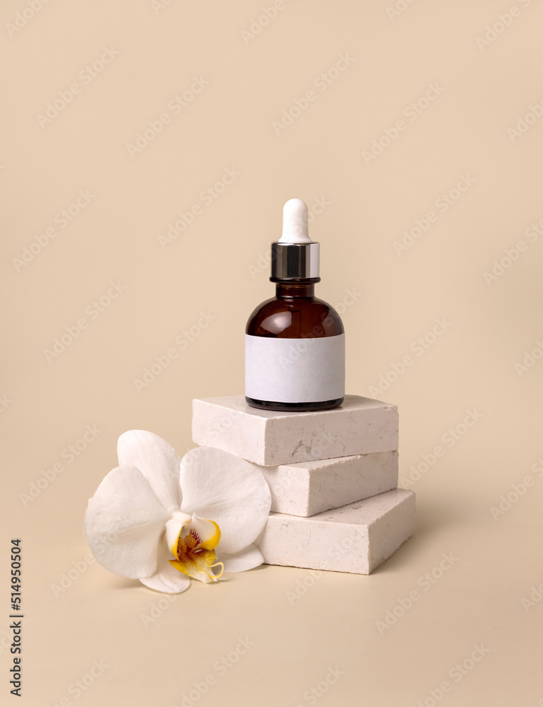 Dropper glass bottle on stone near white orchid flowers on light yellow, Cosmetic Mockup