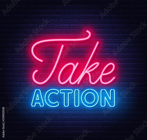 Take Action neon quote on a brick wall.