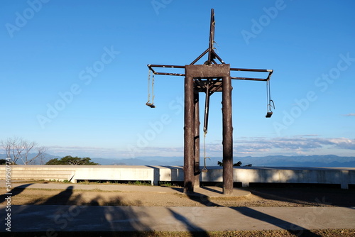 Big wooden swing in the park and blue sky background