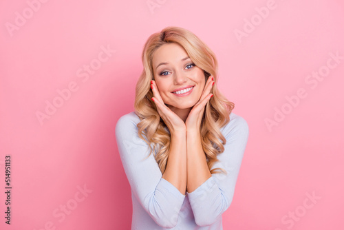 Photo of funny shiny woman wear blue pullover smiling arms cheeks isolated pink color background