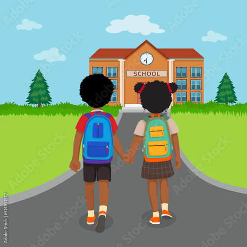 back view of little African kids students with backpacks holding hands walking to school together