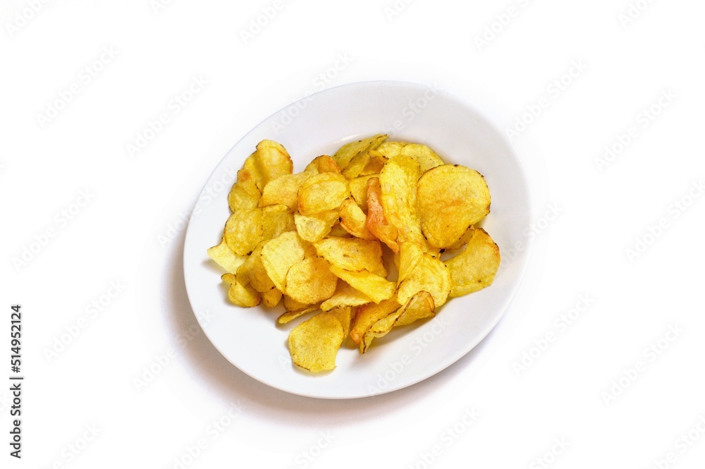 Crispy golden chips on a white plate. Salty snack for beer. Top view food photography for design Crispy golden chips on a white plate. Salty snack for beer. Top view food photography for design