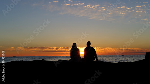 Lovers in front of a summer sunset on the Baltic bay, Mangalsala, lighthouse