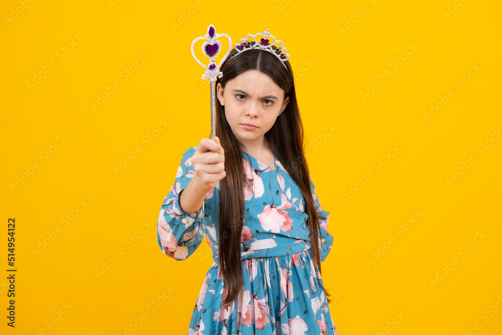 Portrait of girl princess in tiara holding magic wand. Teenager queen with golden crown. Portrait of girl princess in tiara holding magic wand. Teenager queen with golden crown.