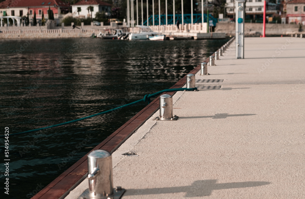 Naklejka premium marina pier bollard and bollards in line on harbour background