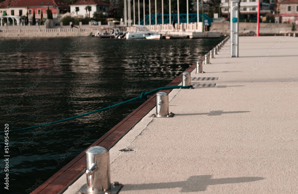 marina pier bollard and bollards in line on harbour background