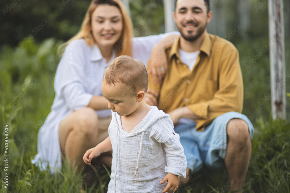 Father, mother and their son are playing with a cat. Family pet. Family time. A happy family.