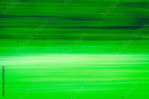 Abstract Green trees motion blurred green leaves background.