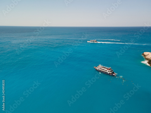 aerial view of porto katsiki beach with cruise boat people having fun