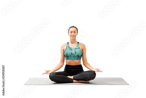 Attractive mixed race woman with closed eyes sitting cross-legged on a mat and practice deep breathing and meditation, isolated on white.