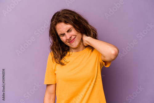 Young caucasian woman isolated on purple background suffering neck pain due to sedentary lifestyle.